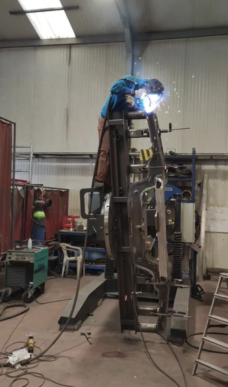 Welder working on a large steel assembly